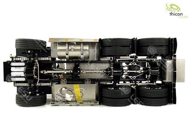 The underside of a model lorry chassis with wheels, suspension and fuel tanks.