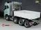 A model lorry with three axles, an open cargo area and a turquoise cab is flanked by the company logos 'ScaleClub' and 'Trickymodels'.