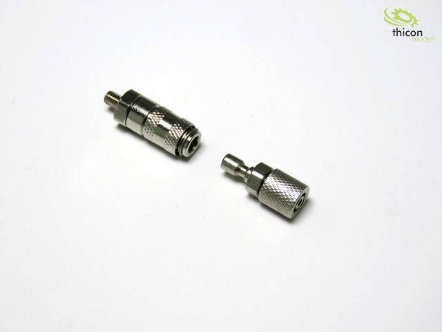 Two metal couplings are lying on a white surface. On the left is a longer coupling with threading, on the right a shorter one, both cylindrical.