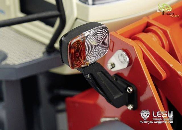 Close-up of a model lorry with intricate rear light and red metal components. Logos for 'LESU' and 'thicon models' are visible.