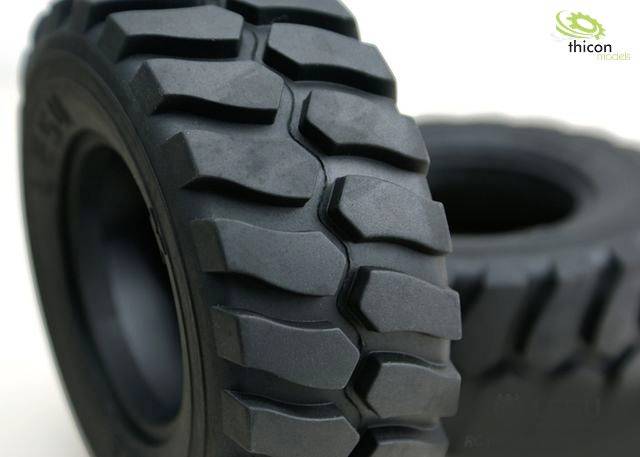 Two large, robust car tyres with deep tread. The surface shows coarse lugs for better traction on uneven surfaces.