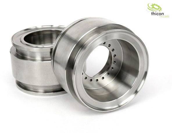 Two metal model components positioned side by side, one upright and the other horizontal. Highly polished with precise perforated patterns.