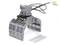 Industrial robot gripper made of metal with cables, positioned on a white background next to two metal plates.