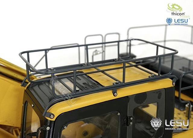A close-up of a yellow model excavator shows the cab with a detailed protective frame on the roof.