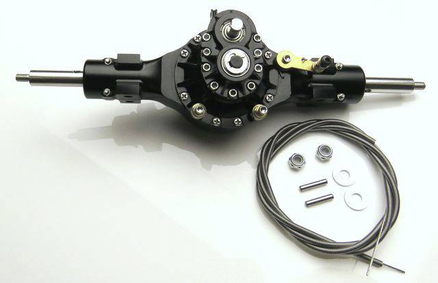 Black metal gearbox with cables, nuts and bolts on a white background.
