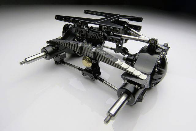 A black and silver machine component with gears and axles, positioned on a white background.