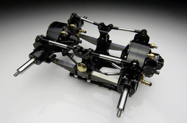Transmission assembly made of metal with multiple gears and axles, detailed and technical, against a neutral background.