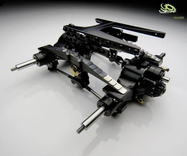 Model of a vehicle axle with various mechanical components made of metal, bolts, and gear structures.