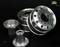 Silver cylindrical metal parts lying on a dark surface. Suitable for mechanical engineering or technical applications.