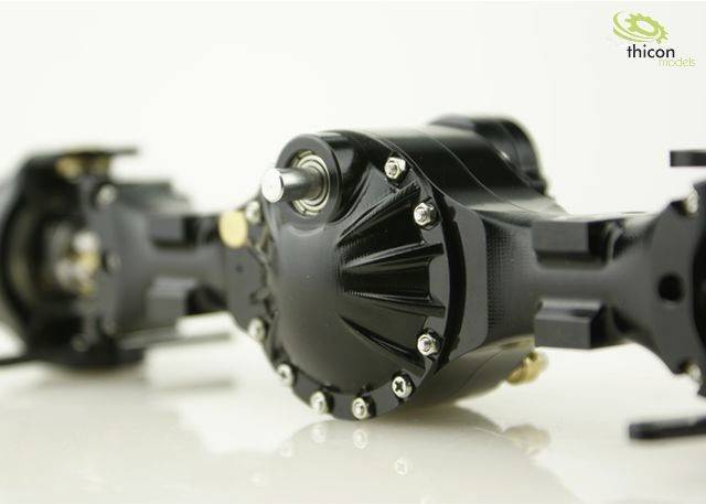 Close-up of a black-painted model railway gearbox with visible screws and details. Thicon models logo in the top right corner.