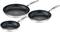 Three black frying pans of different sizes with silver handles, lined up side by side.