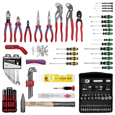 A set of hand tools, including pliers, screwdrivers, spanners, and a hammer, neatly arranged in groups.