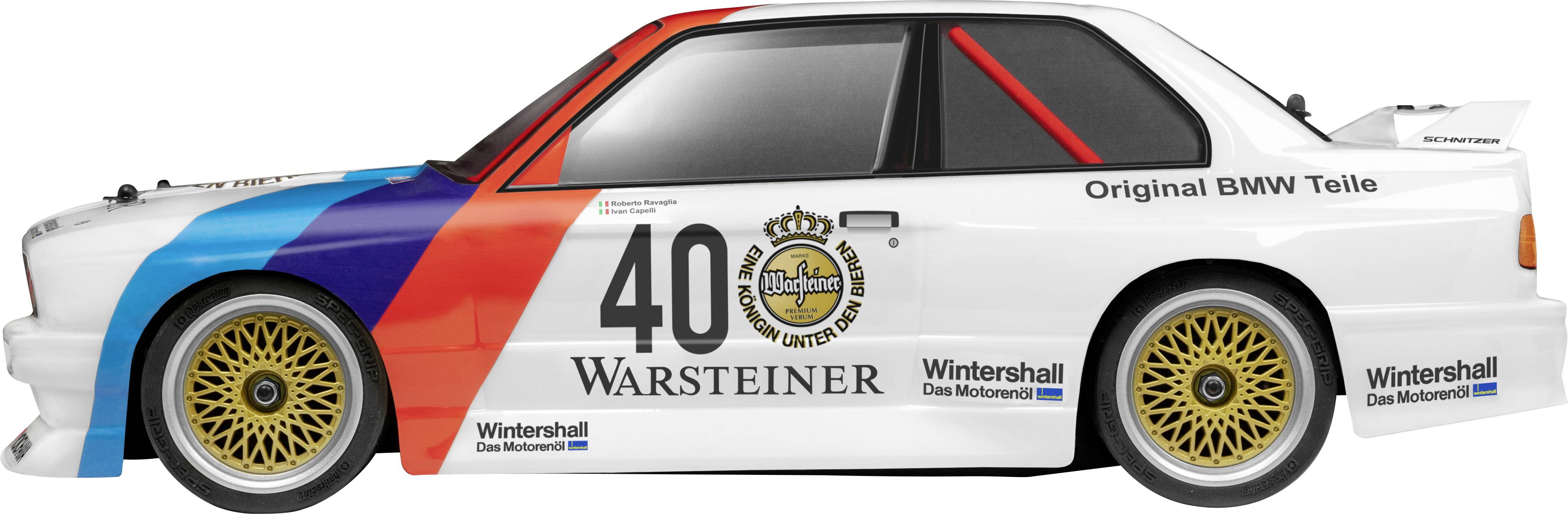 A white BMW racing car, side view, with 'Warsteiner' written on it. It has blue, red, and black accents and a gold wheel rim.