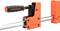 An orange G-clamp with a black handle. It is gripping a piece of metal and is used for holding workpieces in place.