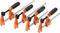 Four orange G-clamps with black handles lined up in a row, ready for use in carpentry or DIY projects.