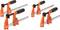 Four orange G-clamps with black handles, arranged in two pairs. They are designed for holding workpieces.