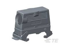 A grey connector housing with a screw-mounted mechanism on a technical drawing.
