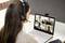 A woman wearing a headset is participating in a video conference meeting on her laptop. Four people are visible on the screen.