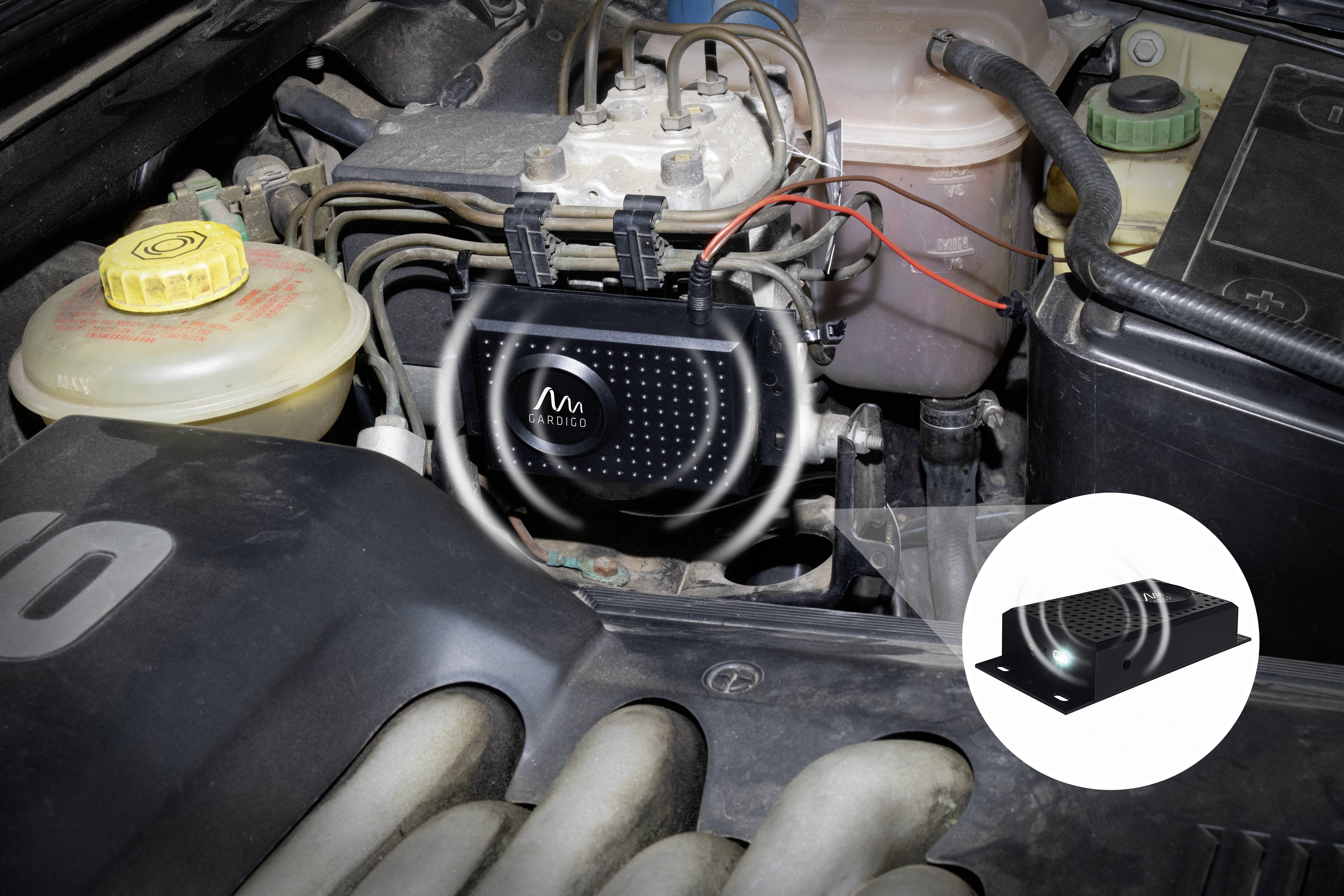 'Engine control of a car with an installed sensor for performance monitoring. The sensor is connected to various cables.'