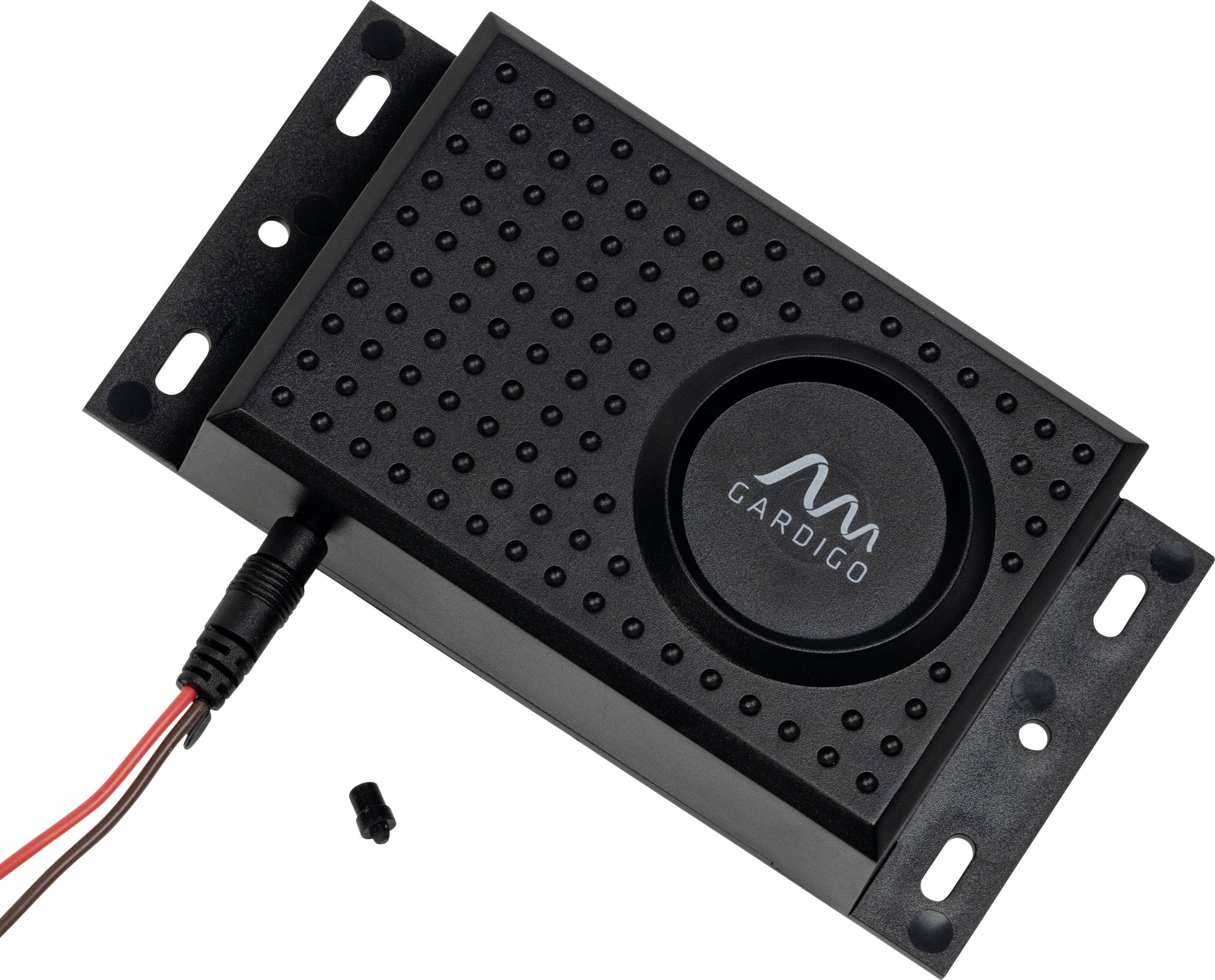 Black electronic device with cables, rectangular in shape, has a round mesh cover in the middle, likely used for electronic control.