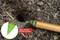 Garden tool with green attachment drilling hole in earth. Text: 'Soil-hole drilling aid makes insertion easier!'