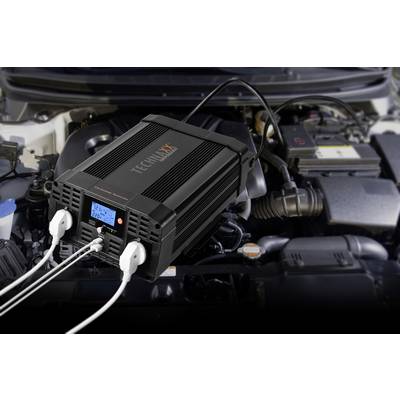 Auto-inverter in the engine compartment, connected to a car battery, converts direct current to alternating current; for mobile power supply.