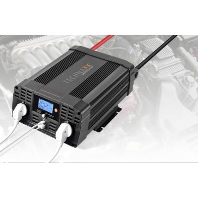 A black voltage converter with two plug sockets and a display shows '12.7V 220V'. A motor compartment is visible in the background.