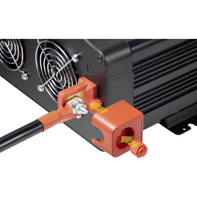 Red plastic cap is fitted to a black electronic device, cables connected; power connection, securing mechanism.