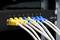 Yellow and blue Ethernet cables connected to a CAT 6A network switch, numbered from 1 to 8.