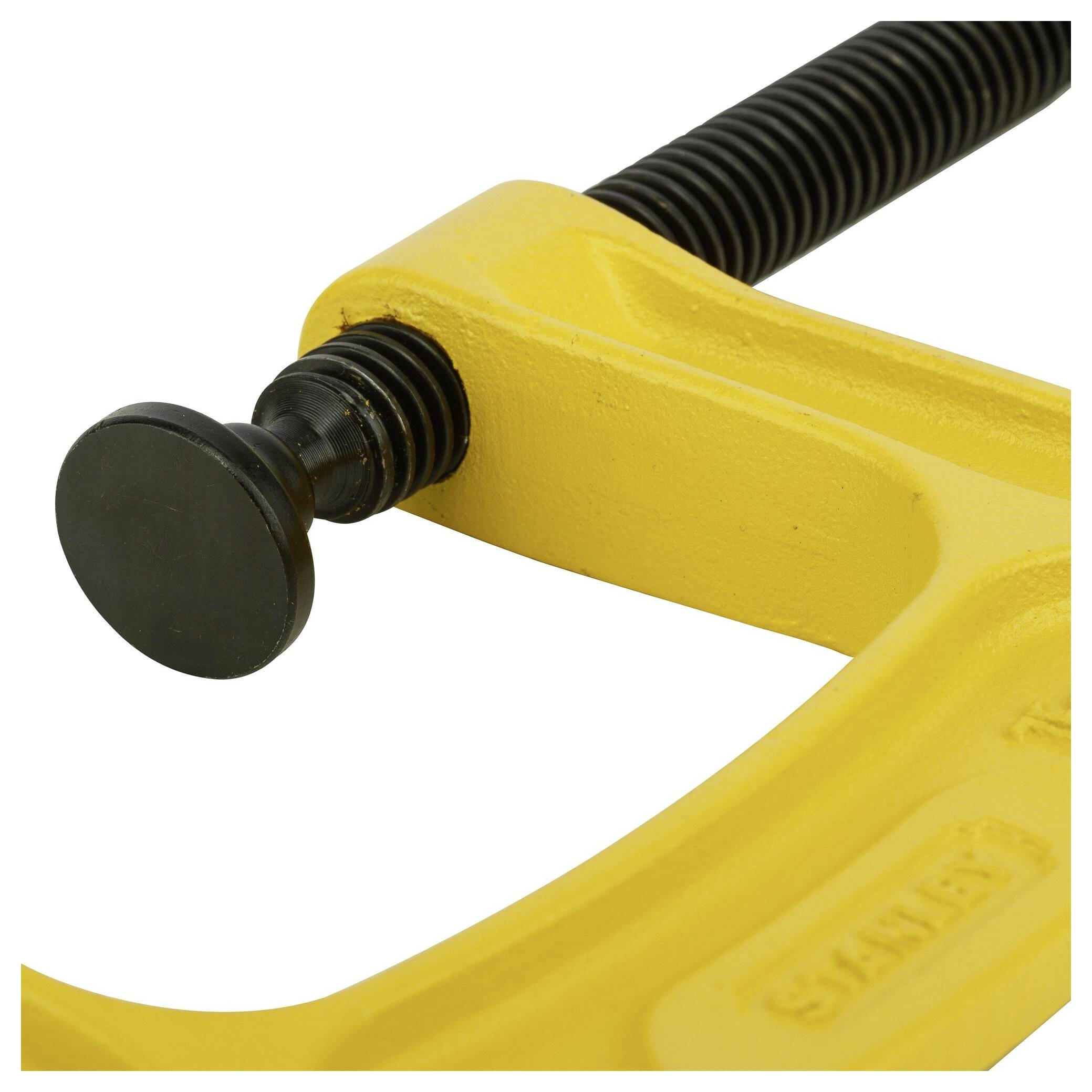 Close-up of a yellow G-clamp with a black spindle.