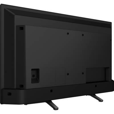 A black television is seen from behind, with stand feet. The rear panel shows several connection ports and mounting points.