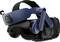 A VR headset with a dark design and blue accents. It features adjustable head straps and integrated headphones.