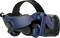 Virtual reality headset in blue and black with adjustable headband, padded ear cups, and cable connection on the right.