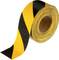 A roll of adhesive tape with yellow and black stripes as a warning marker.