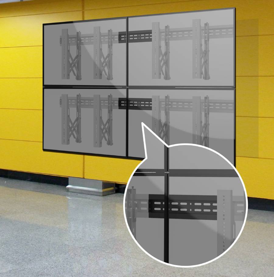 'Video Wall' with four screens mounted on a yellow wall. An enlarged section shows the mounting brackets of the screens.