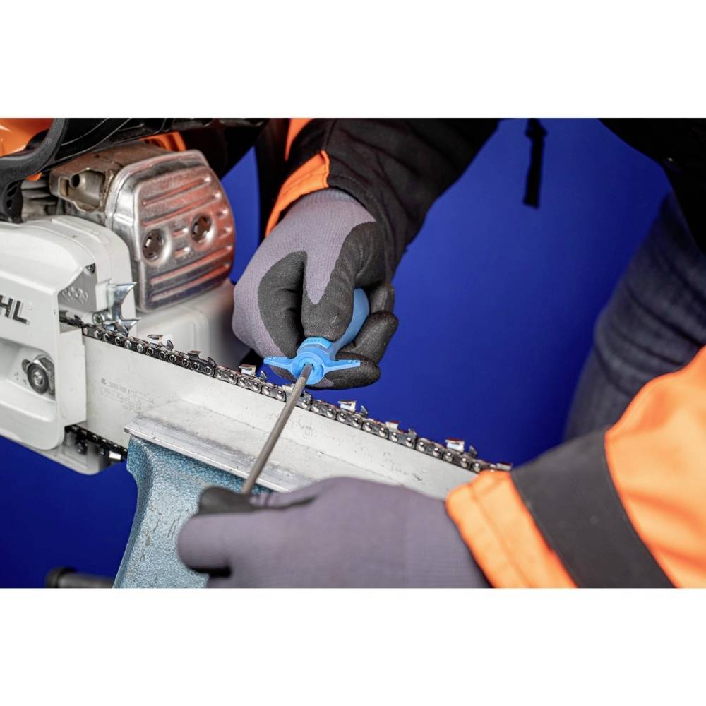 'A person is sharpening the chain of a chainsaw with a file. They are wearing protective clothing, including gloves and a jacket.'