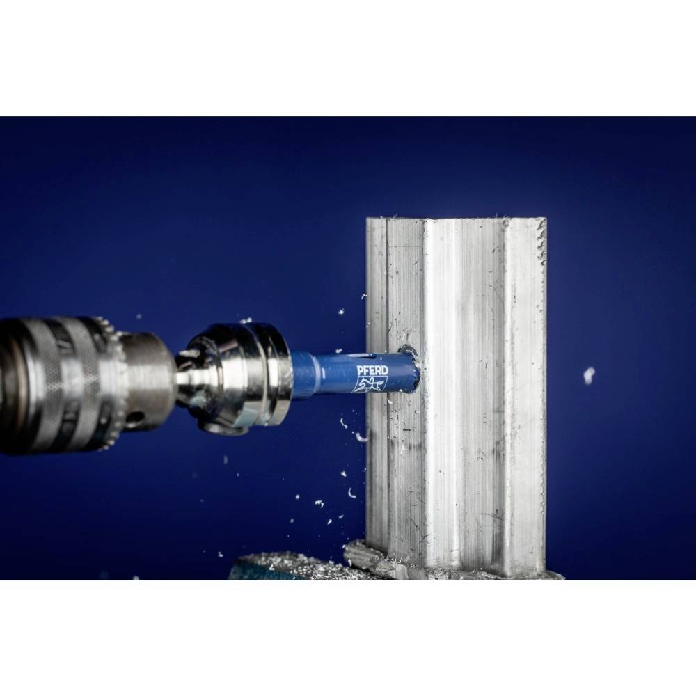 A drill is boring a hole into a piece of metal. Metal shavings are flying away from the point of contact and the drill is visibly in motion.