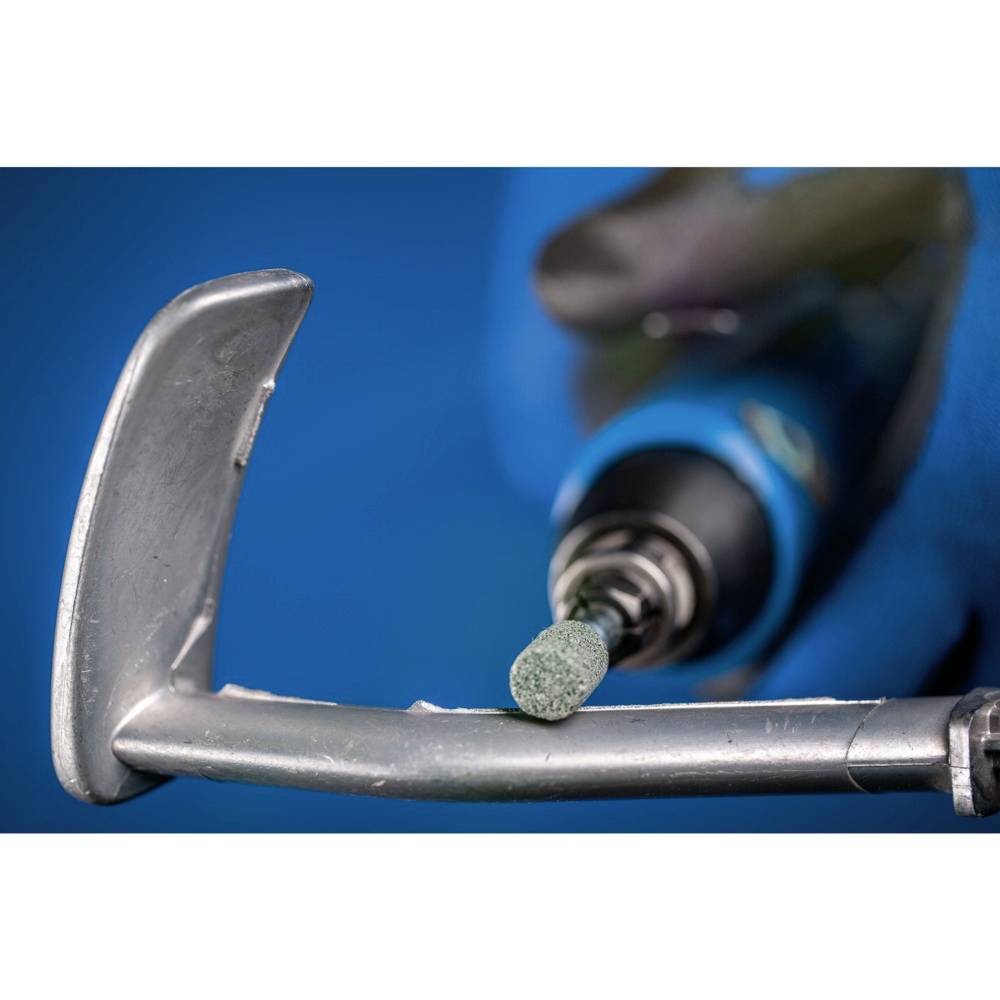 'A person is smoothing the metal sheet of a golf club with an electric tool to refine the surface.'