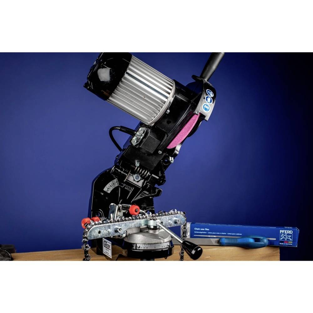 Machine for sawing metal on a wooden table, with a blue background. A saw blade is clamped in place, ready for use.