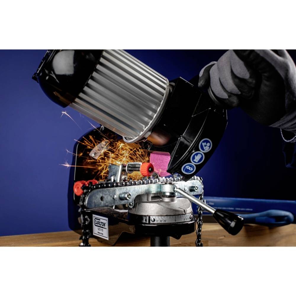 An angle grinder with a rotating disc grinds metal, sparks flying. A gloved hand holds the tool, which is secured to a table.