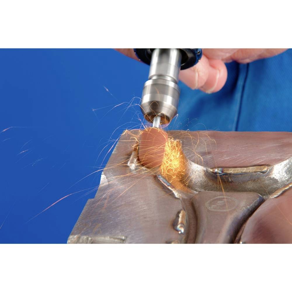 A close-up shows a hand holding a drill. Sparks fly as it drills into a metal surface.