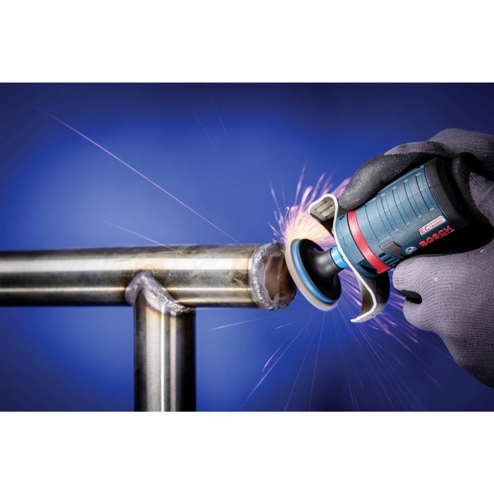 A person is using an angle grinder to process a metal pipe. Sparks are flying as the tool is applied to the pipe. The working environment is professional.