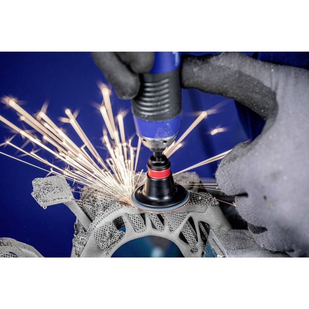 A person is grinding metal with an electric tool, creating sparks. They are wearing protective gloves to prevent injuries.
