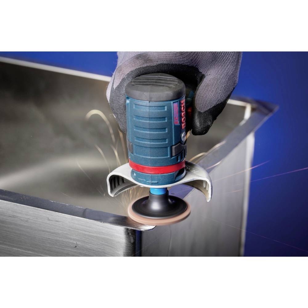 Close-up of a gloved hand using an electric grinding tool to smooth the edge of a metal object.