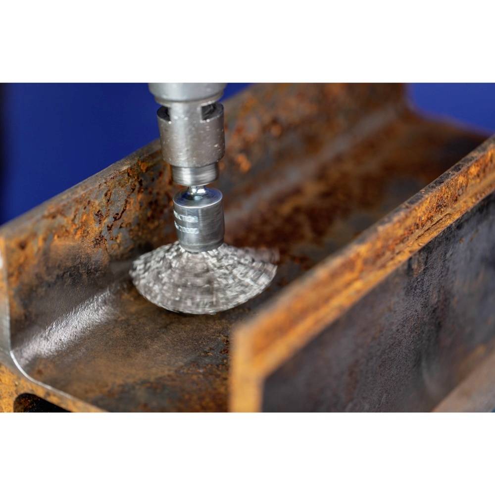 A metal pipe is being cleaned of rust and smoothed using a rotating tool.