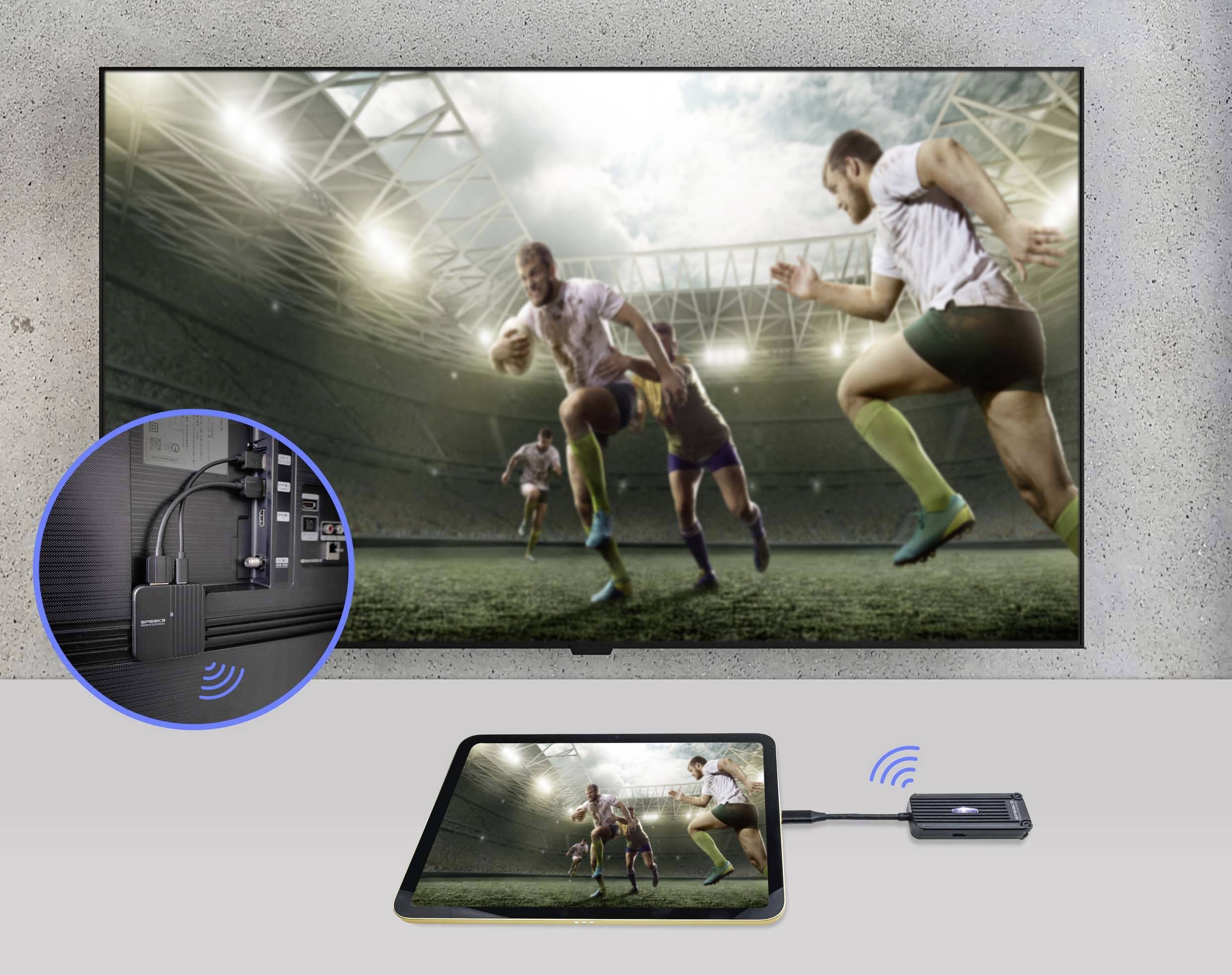 A tablet is wirelessly streaming a rugby match onto a television. An adapter is plugged into the tablet, which enables the streaming.