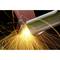 Sparks are flying from a metal being worked with a grinding machine.