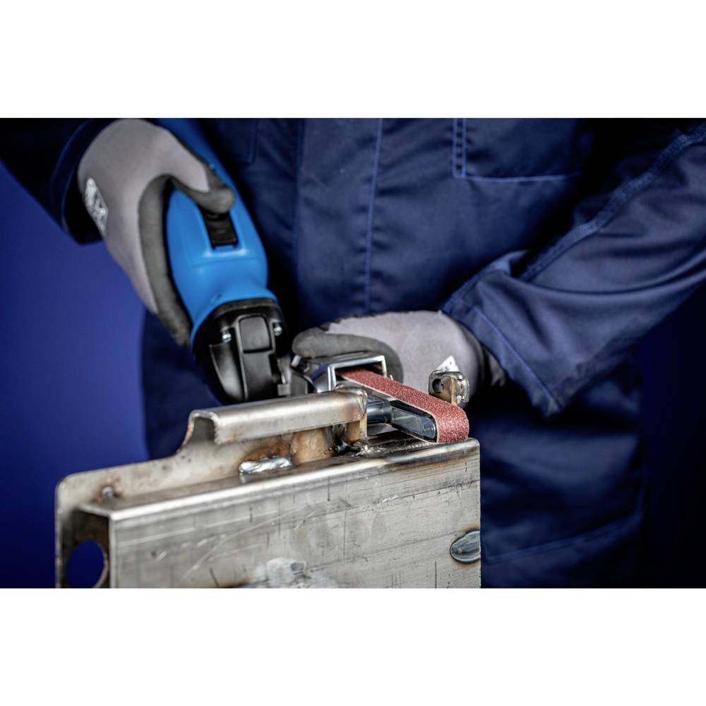 Person in protective gear grinding metal with an angle grinder. The image shows the grinding process in close-up.