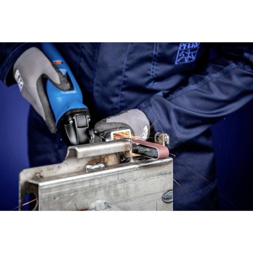 A person in blue workwear is grinding metal with an angle grinder. Sparks are flying from the workpiece being processed.