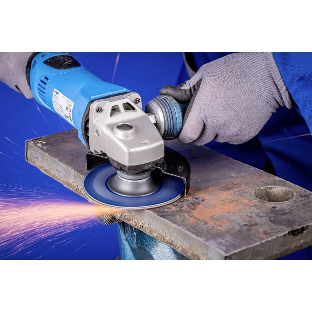 A person is grinding metal with an angle grinder. Sparks are flying from the grinding point as the machine is moved along the edge.